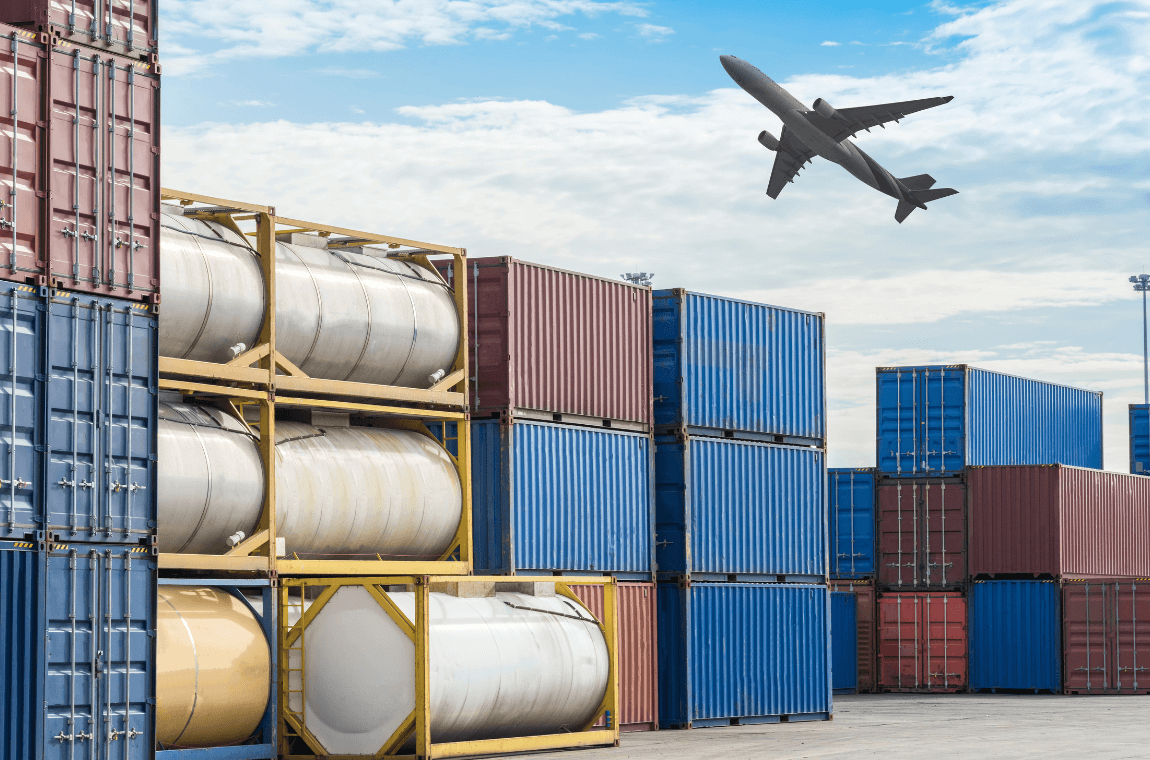 Cargo airplane flying over stacked containers illustrating capacity constraints in global air freight