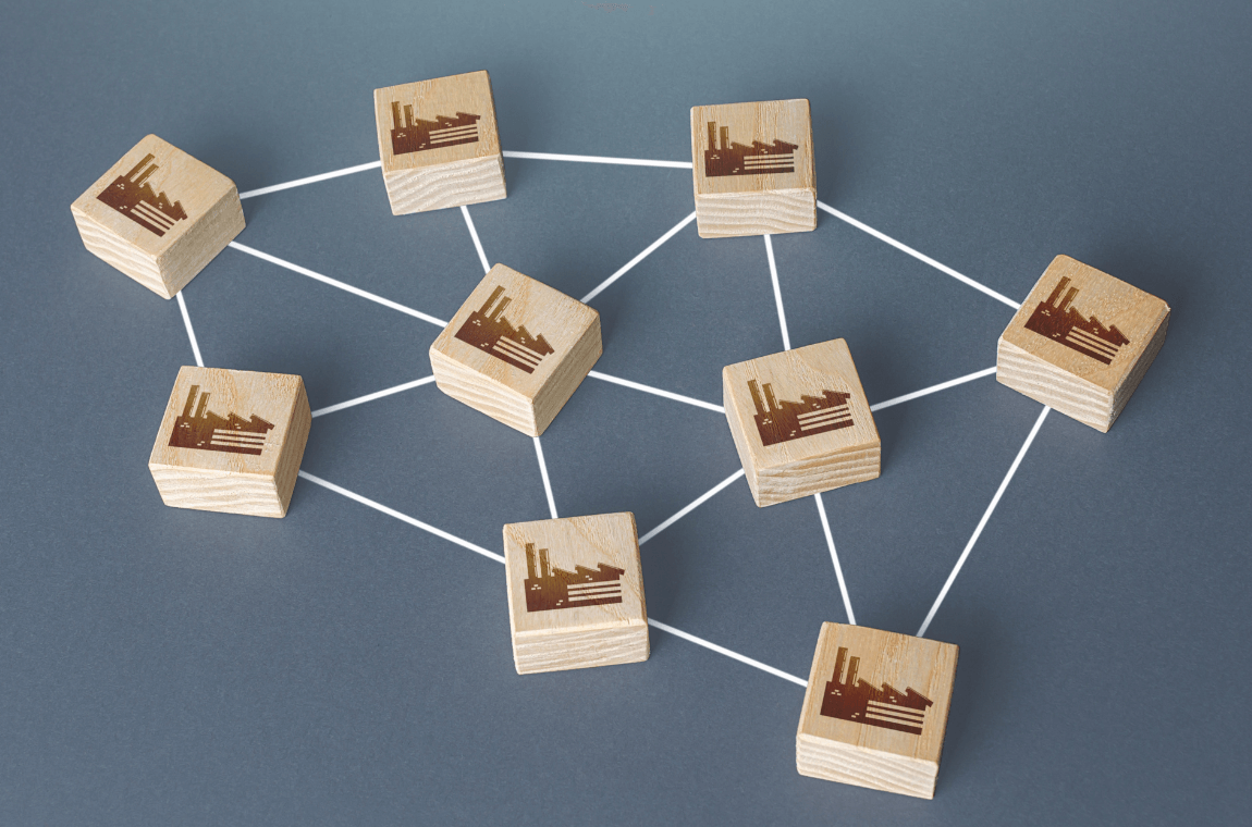 Wooden blocks with warehouse images connected by rope, illustrating capacity constraints in logistics.